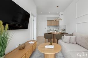 a living room with a couch and a table at Apartament Hygge - z basenem - Easy-Rent Apartments in Pobierowo