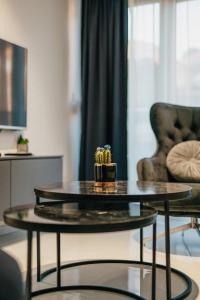 a living room with a table and a chair at Damast Lux apartments 20 in Ohrid