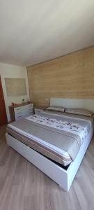 a bedroom with a large bed in a room at Appartamento Orobie in Colere +4 photos
