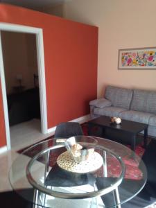 a living room with a glass table and a couch at Garden Hotel Catania in San Giovanni la Punta