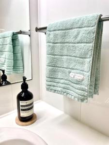 a bathroom with a bottle of soap on a sink at Edge17 Waterfront Apartment, plus Cottage with Garden View - Port Fairy in Port Fairy