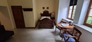 a bedroom with a bed and a table and chairs at Pałac Książęcy we Wleniu in Wleń