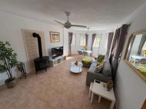 a living room with a couch and a wood stove at Turre Villa - 3 bedroom - sleeps 8 - R130 in Turre