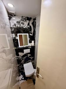 a bathroom with a toilet and a mirror at Luxury Apartment Ocean View and Private Beach Ain Diab in Casablanca +15 photos