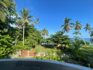 a view from the balcony of a resort with palm trees at Villa Flux in Locbol