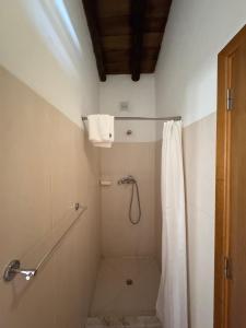a bathroom with a shower with a shower curtain at Casinha do Chafariz - Casas da Amieira in Amieira