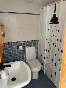 a bathroom with a white toilet and a sink at Medeea's Spanish Sunny Escape in Vinarós +3 photos