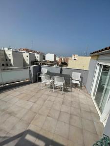 a patio with chairs on a roof at Medeea's Spanish Sunny Escape in Vinarós