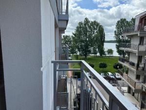 an apartment balcony with a view of a parking lot at Apartament NADJEZIORNA EŁK in Ełk