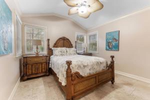 a bedroom with a large bed and a ceiling fan at Villa La Esperanza-Holmes Beach 201 in Anna Maria Island +66 photos
