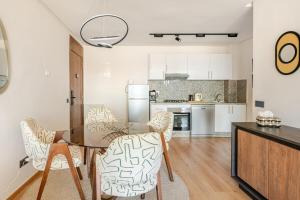 a dining room with a glass table and chairs at Au Petit Port Balcony & Sea view 5 mn from casa-port in Casablanca +22 photos