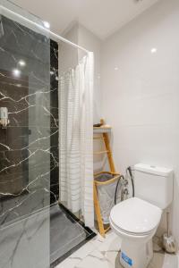 a bathroom with a toilet and a shower at Au Petit Port Balcony & Sea view 5 mn from casa-port in Casablanca