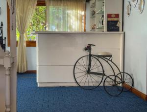 a bike parked next to a dresser in a room at Petit Hotel Provence Gramado in Gramado