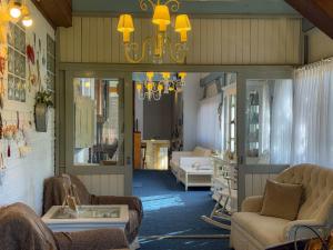 a living room with a couch and a chandelier at Petit Hotel Provence Gramado in Gramado