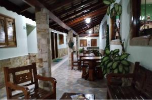 a room with chairs and a table in a building at Pousada Vista Alegre in Guaratinguetá