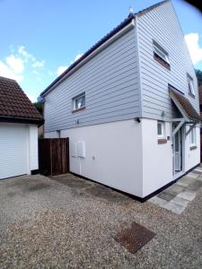 a large white garage with a white door at 'Ks' Yard in Great Dunmow