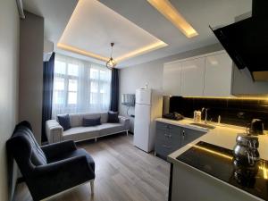 a kitchen and living room with a couch and a table at Levent Apart in Trabzon +15 photos