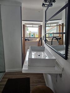 a bathroom with a white sink and a mirror at Casas Sebastião - Tourist House in Caminha +45 photos