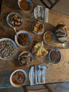 a table with many plates of food on it at Bata GuesThouse in Adishi
