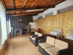a room with three beds and a table and chairs at Casa Jardín in Monforte de Lemos