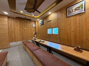 a conference room with wooden panel walls and benches at Hotel HD Residency A Unit By Hotel Harbans in Patiāla