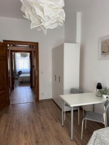 a living room with a table and a white ceiling at Pokoje u Bolka Świdnickiego in Świdnica