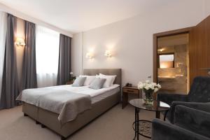 Postel nebo postele na pokoji v ubytování Grottger Luxury Boutique Hotel City