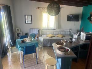 a small living room with a bed and a table at Villas Vista Del Mar in Kissamos
