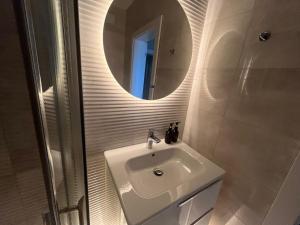 a white bathroom with a sink and a mirror at Helen & Friends 3 bedrooms in Balchik +28 photos
