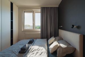 a bedroom with a bed with two bags on it at Białoprądnicka - Stay&Park in Kraków
