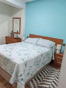 a bedroom with a large bed and a mirror at Arenal confort in Marín