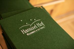 a green book with the words hansel hop on it at Hanusel Hof Wellness & Genuss in Panoramalage in Hellengerst