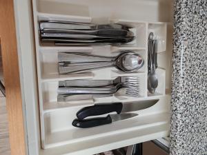 a drawer full of utensils in a cabinet at Arenal confort in Marín
