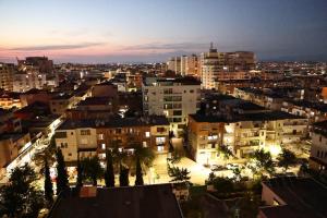 a view of a city at night with buildings at Nova Luxury Apartment in Durrës