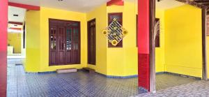 a brightly colored building with two doors on it at Casa Orquídea Alter do Chão in Alter do Chao