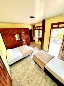 Postel nebo postele na pokoji v ubytování Casa Orquídea VILA- HOSPEDARIA
