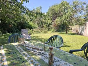 a table with a table cloth on it with two chairs at Maison de campagne avec jardin Chez nous 