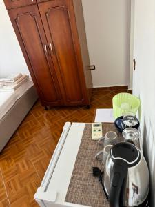 a room with a table with a tea kettle and a cabinet at Room with amazing sea view in Himare