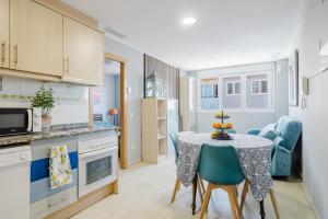 a kitchen and dining room with a table and chairs at Chillout Grau de Gandia- attico para 6 personas dos banos VT-44956-V in Gandía +19 photos