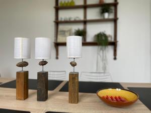 a group of three lamps on a table with a bowl at Historic Centre Duplex - Ghent Belfry & St Nicholas Church View in Ghent +24 photos