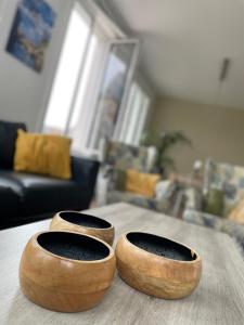 two wooden bowls sitting on a table in a living room at Historic Centre Duplex - Ghent Belfry & St Nicholas Church View in Ghent
