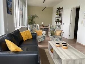 a living room with a couch and a coffee table at Historic Centre Duplex - Ghent Belfry & St Nicholas Church View in Ghent