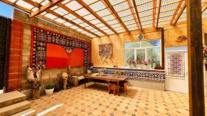 a large room with a table and a window at Guest House Ormon in Ak-Muz