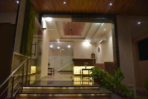a lobby of a building with stairs and a table at RROOMS Hotel Riddhi Grand in Lucknow