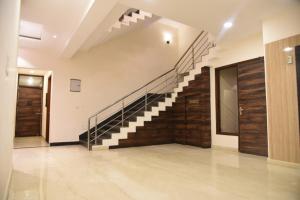 a lobby with a staircase in a building at RROOMS Hotel Riddhi Grand in Lucknow