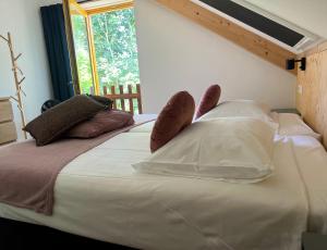 a bedroom with a large white bed with shoes on it at Hoeve Consensus Texel in Den Burg