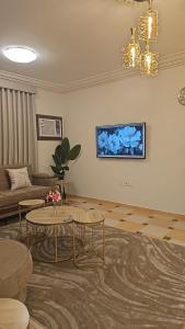 a living room with a couch and a table at Orchid Private Tourism Accommodation Facility اوركيد - لمرافق الضيافة السياحية الخاصة in Medina