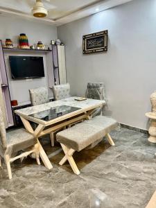 a dining room with a table and two chairs at Malik House Ali block Bahria town karachi in Karachi