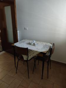 a dining room table with two chairs and a table with at Sognando Ostuni in Ostuni +2 photos