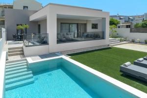 a villa with a swimming pool and a house at Kritida Villa Luxury Nest with heated pool in Kokkini Khanion